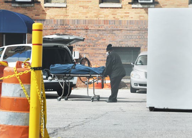 Một nhân viên của nhà tang lễ C.W. Morris ở Highland Park chuyển thi thể từ bệnh viện Sinai-Grace. (Ảnh: Detroit News)